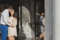 Couple embracing under golden sunlight in Venice