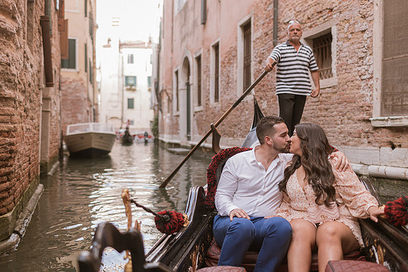 Couple holding hands after proposal on gondola
