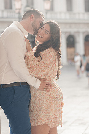 Engaged couple sharing a romantic moment in Venice