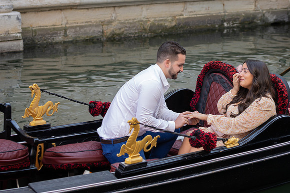 Engaged couple enjoying gondola ride in Venice