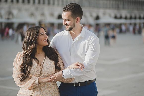 Engaged couple laughing in Venice