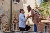 The newly engaged couple shares a passionate kiss on Ponte Chiodo.