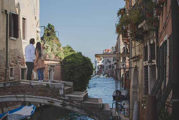 A couple pauses on a quiet bridge, setting the scene for an unforgettable moment.