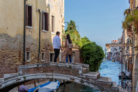 A beautiful moment as the couple stands on Ponte Chiodo, surrounded by Venetian charm.