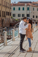 An intimate moment with Venice’s charming bridges in the background.