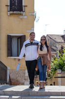 The couple walks along the historic streets of Cannaregio, savoring the moment.