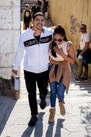 A candid shot of the couple walking hand in hand after the proposal.