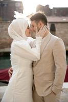 Engaged couple in golden hour light near a canal in Venice.