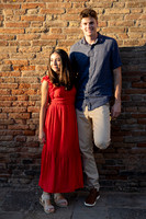 Couple by brick wall in Venice after engagement