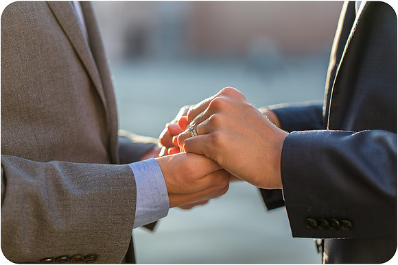 Close-up of engaged couple holding hands in Venice.