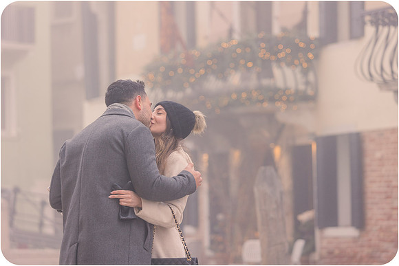 Couple walking on foggy Venice street after engagement