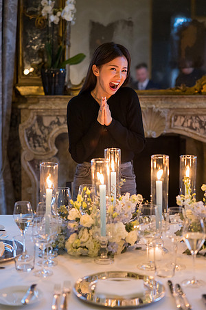 The groom-to-be prepares to propose in a stunning candlelit setting.
