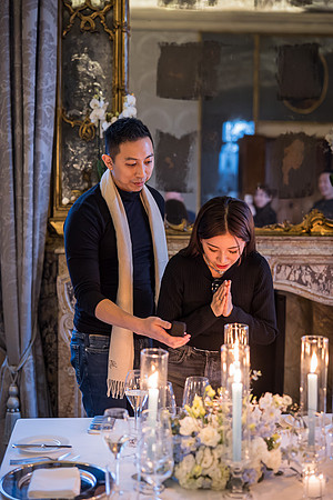 An emotional proposal set against the warm glow of candlelight.