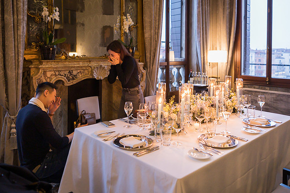 The couple shares a tender kiss in the candlelight.
