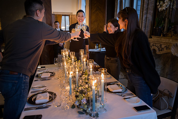 The couple shares a private moment, surrounded by glowing candles.