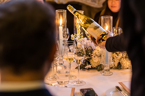 The engagement ring sparkles in the candlelight, capturing the moment.