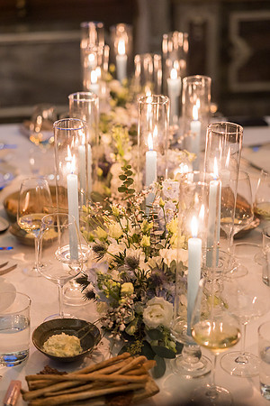 A couple enjoys their private dinner surrounded by candlelight.