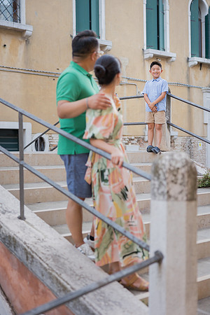 Family crossing a bridge during their Venice vacation