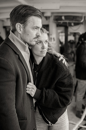 The couple shares an intimate gaze while wandering through a Venetian market.