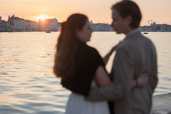Couple walking hand in hand along canal