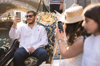 Family enjoying a special moment on a gondola near the Rialto Bridge in Venice