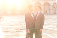 Couple embracing in Piazza San Marco during sunrise.