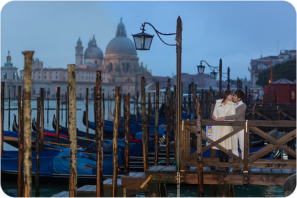 Lesbian couple admiring the gondolas in Venice.