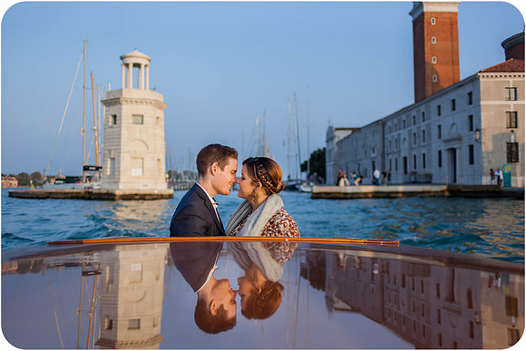 Man proposing to his partner near the waterfront with Venice’s landmarks behind them.