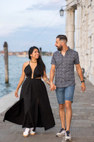 Couple walking along Grand Canal after proposal in Punta della Dogana.