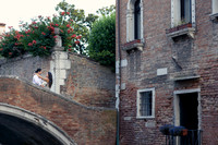 Romantic couple sharing a quiet moment on a Venice bridge.