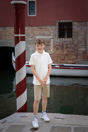 Brothers standing by the canal in Cannaregio, Venice.