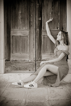Model seated on steps in Venice.