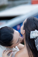 Couple leaning in for a kiss, blurred gondolas in the background.