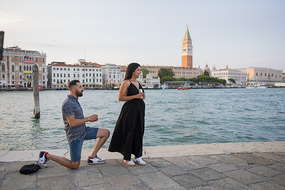 Bride-to-be reacting to sunset proposal with St. Mark’s Campanile in view.
