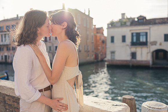 Partners embracing by Venice canals