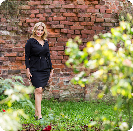Woman walking through a garden in Milan.