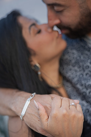 Engagement close-up at sunset with loving expression.