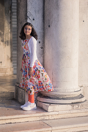 Young girl by Venetian columns