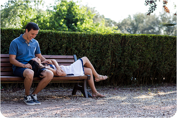 Couple kissing in a Roman park during their summer honeymoon