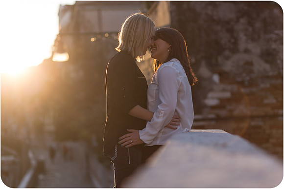 Couple relaxing by the canal in Venice during their same-sex honeymoon.
