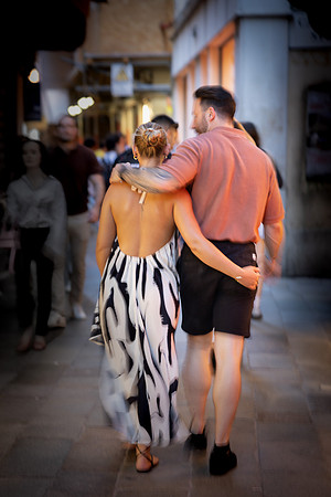 Couple leaning against bridge in Venice engagement