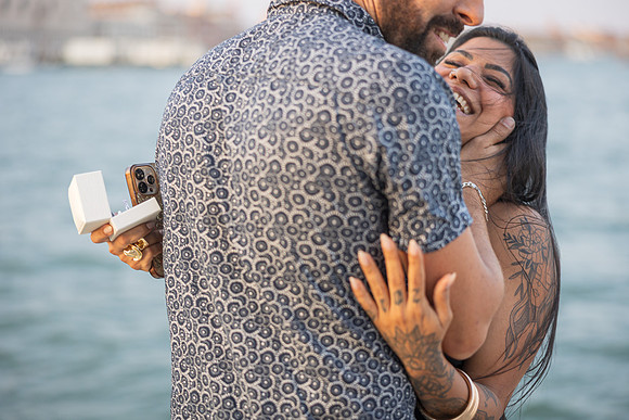 Close-up of newly engaged woman showing ring near Grand Canal.