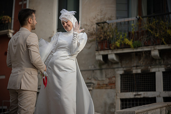 Couple smiling at each other after a proposal in Venice.