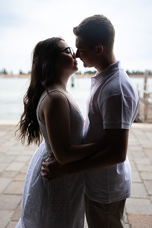 Silhouette of engaged couple standing by the Venetian waterfront