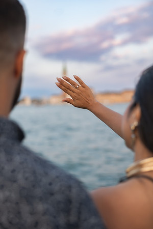 Newly engaged woman waving across the Grand Canal from Punta della Dogana.