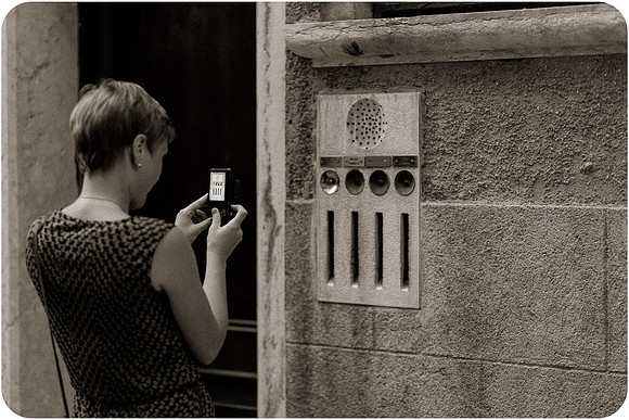 Lesbian woman taking a photo with a camera in Venice.