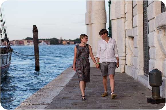 Lesbian couple walking along the shore in Venice.