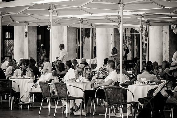 Engaged couple smiling at Café Florian