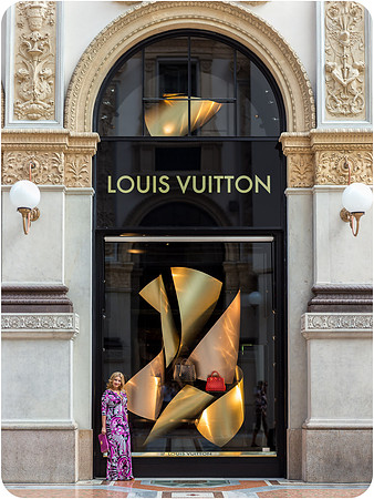 Woman posing outside Louis Vuitton in Milan.