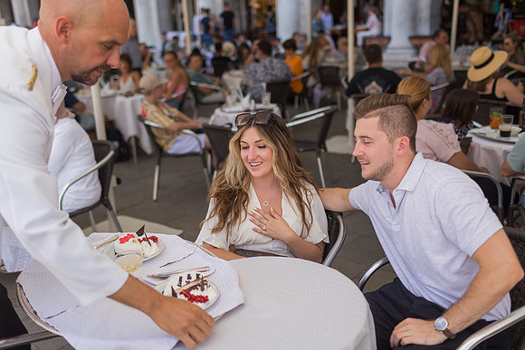 Engaged couple gazing at Café Florian
